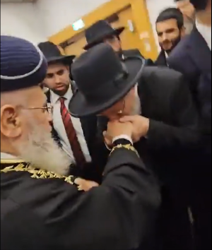 הרב זעפרני מנשק את ידו של מרן בחתונת נכדתו-ליל יג חשון פה.PNG